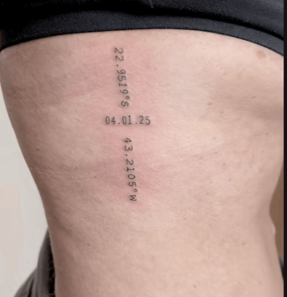 Small coordinate tattoo on the rib cage