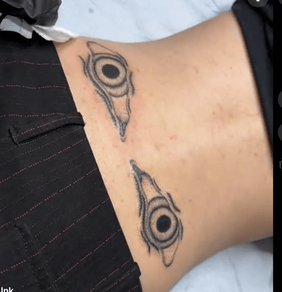 19. Evil Eye Lower Back Tattoo