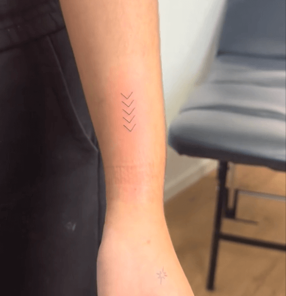 Mini arrow tattoo on hand