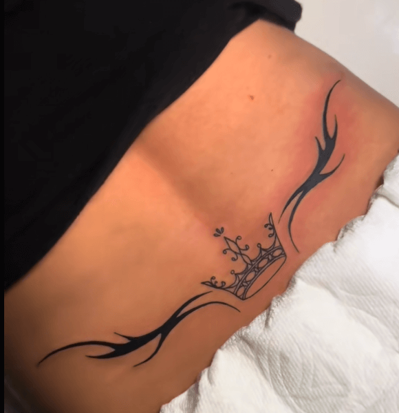 A Queen crown lower back tattoo and Tribal Tattoo elements.