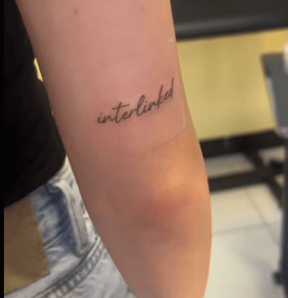 “Interlinked.” quote tattoo