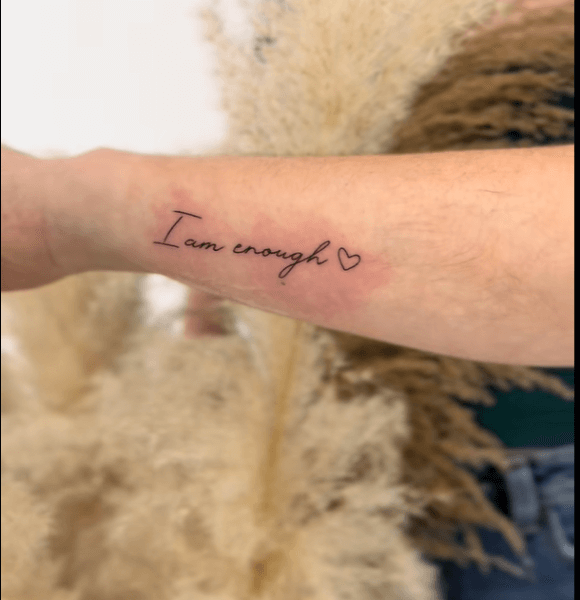 "I am enough." deep meaning tattoo on the hand.
