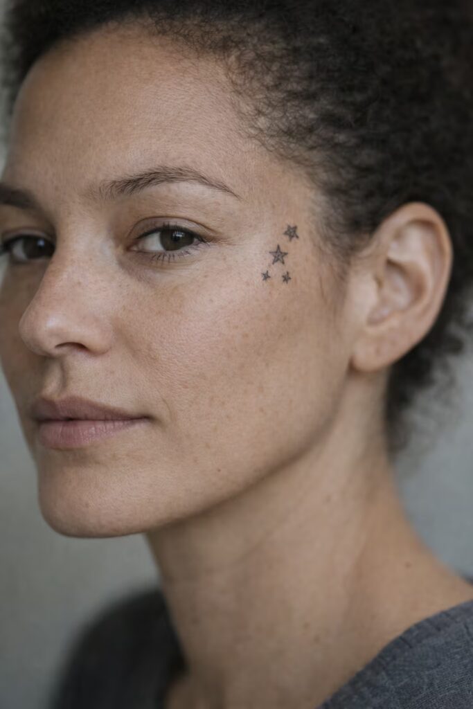 Clustered Star Small face tattoo