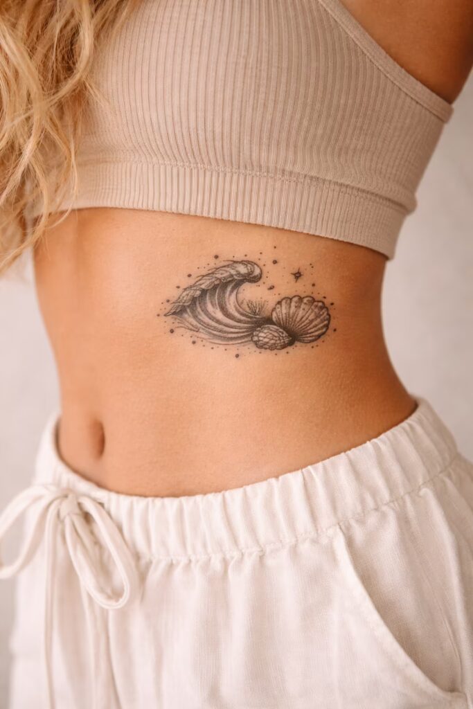 13. Dotwork Ocean Waves & Seashells Side Tummy Tattoo